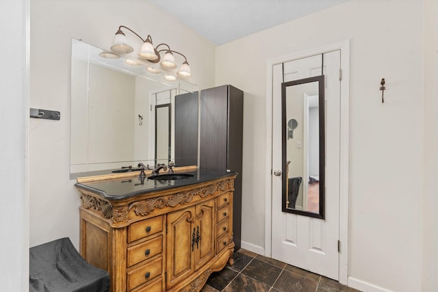 bathroom with vanity and baseboards