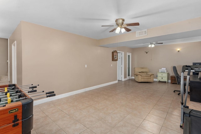 kitchen featuring a ceiling fan, baseboards, light tile patterned floors, and open floor plan
