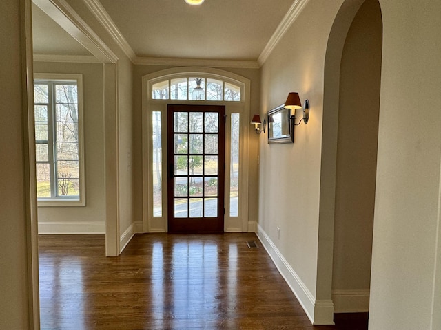 entryway with dark wood-style floors, baseboards, and ornamental molding