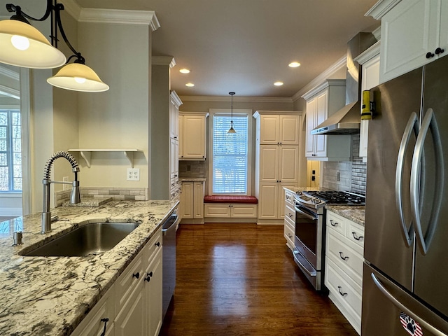 kitchen featuring dark wood-style flooring, plenty of natural light, stainless steel appliances, and a sink