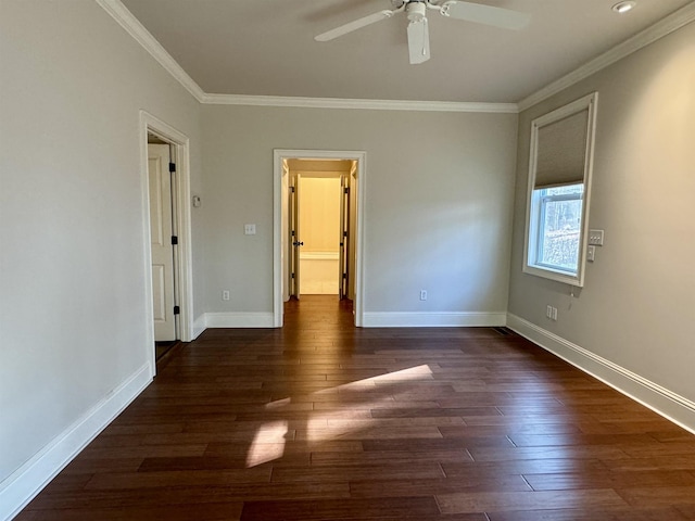 empty room featuring a ceiling fan, dark wood-type flooring, baseboards, and ornamental molding