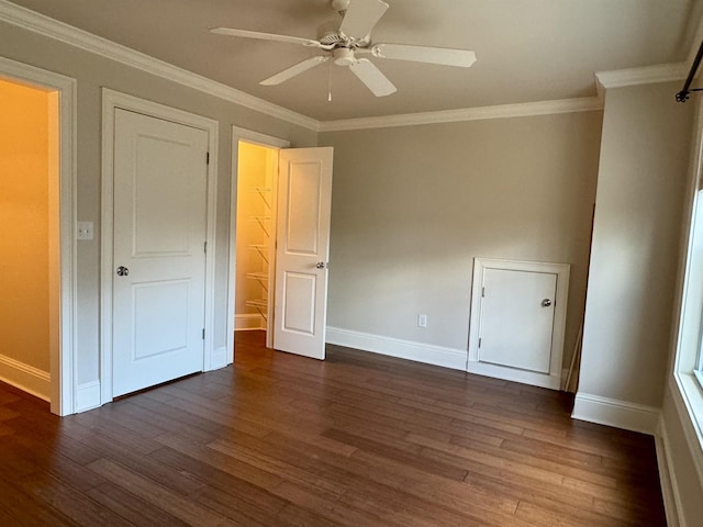 unfurnished bedroom with ceiling fan, baseboards, dark wood-style floors, and ornamental molding