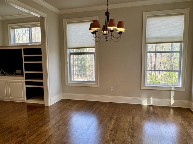 unfurnished dining area featuring dark wood-style floors, a wealth of natural light, and ornamental molding