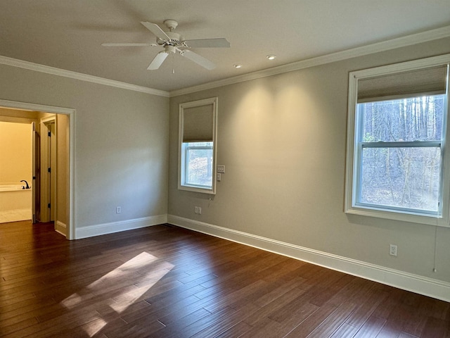 empty room featuring a ceiling fan, dark wood-style floors, baseboards, and ornamental molding