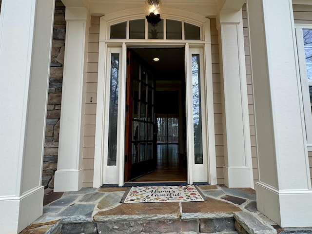 view of exterior entry with a porch