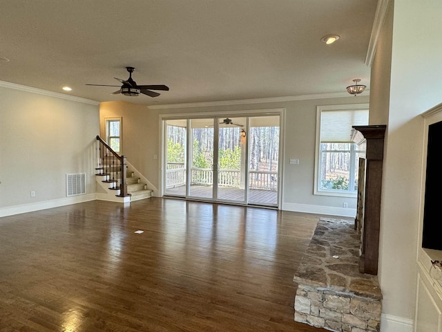 unfurnished living room featuring visible vents, baseboards, ceiling fan, dark wood finished floors, and ornamental molding