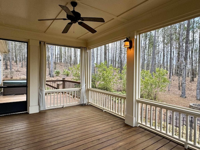 unfurnished sunroom featuring ceiling fan