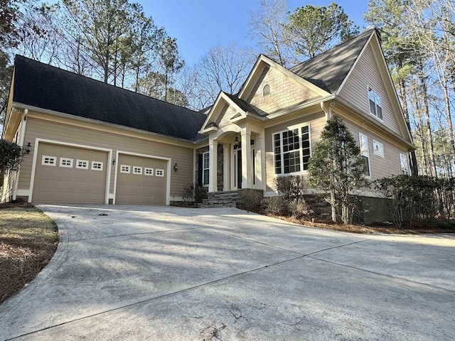 view of front facade with concrete driveway and an attached garage