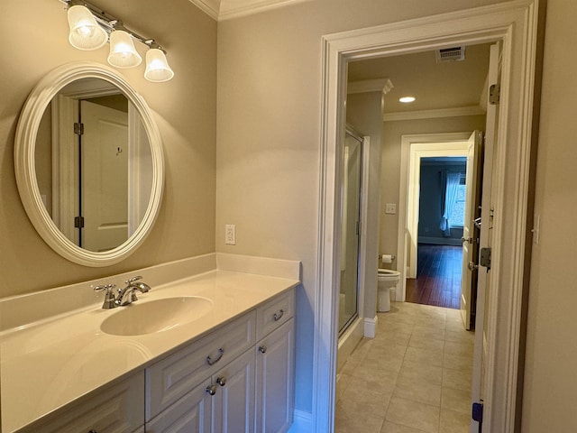 full bath featuring vanity, visible vents, tile patterned flooring, crown molding, and toilet