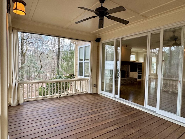 unfurnished sunroom featuring plenty of natural light and ceiling fan