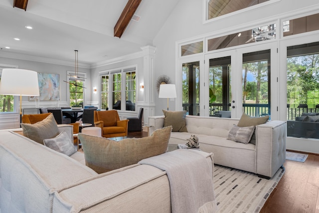 living room with french doors, light wood-type flooring, ornamental molding, beamed ceiling, and decorative columns