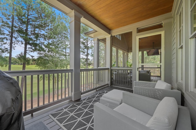 sunroom featuring wooden ceiling