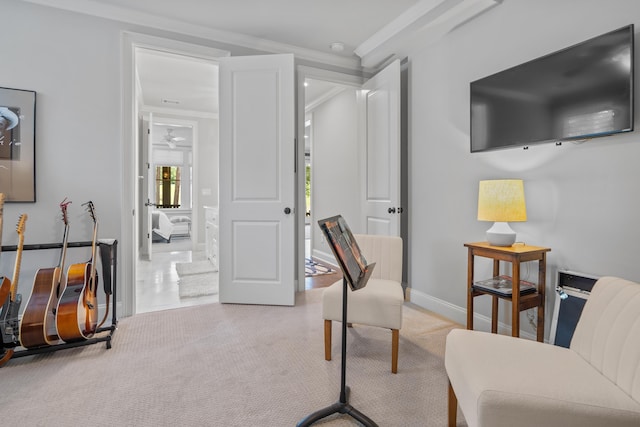 living area with ornamental molding and light carpet