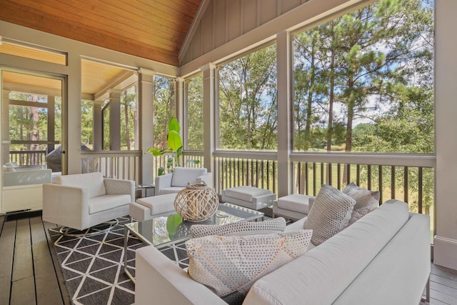 sunroom with lofted ceiling, a healthy amount of sunlight, and wooden ceiling