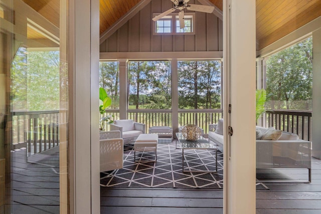 doorway featuring lofted ceiling, wood-type flooring, and ceiling fan