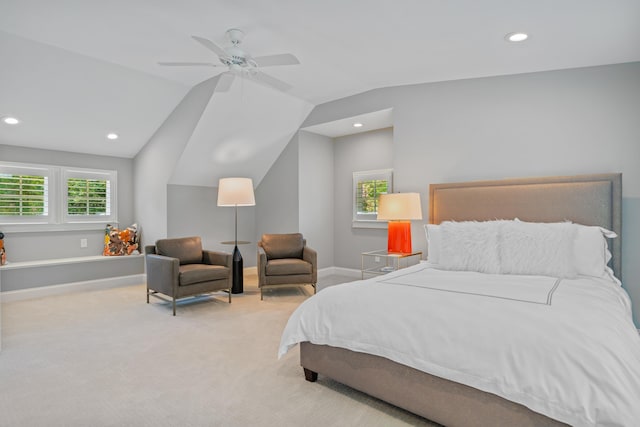 bedroom with multiple windows, vaulted ceiling, light colored carpet, and ceiling fan