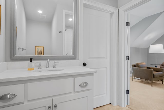 bathroom featuring vanity and vaulted ceiling