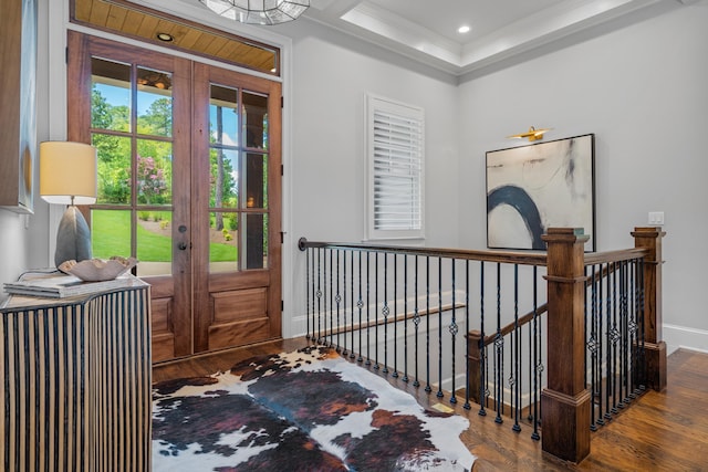 entryway with hardwood / wood-style flooring, crown molding, a tray ceiling, and french doors