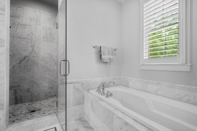 bathroom featuring independent shower and bath