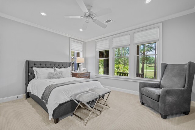 bedroom featuring crown molding, light colored carpet, and ceiling fan