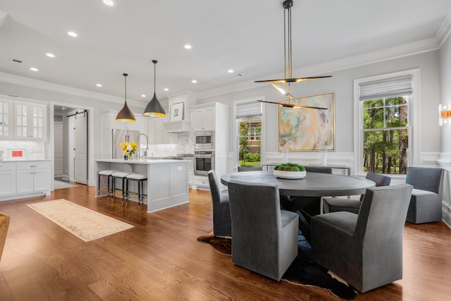 dining room featuring ornamental molding, dark hardwood / wood-style flooring, and a wealth of natural light