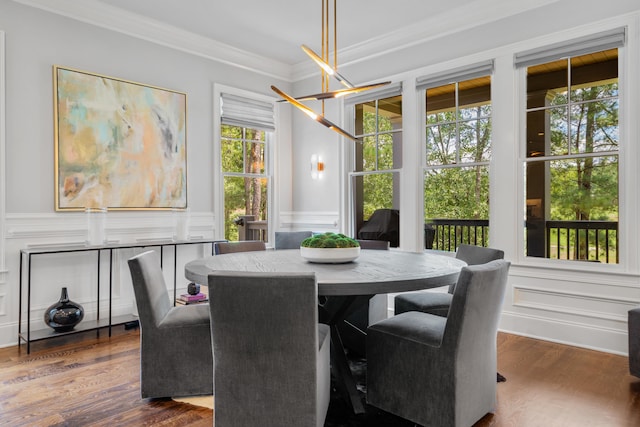 dining room featuring dark hardwood / wood-style flooring and crown molding