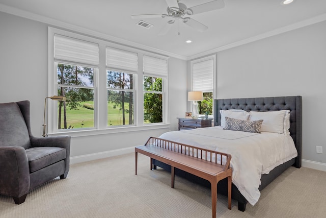 carpeted bedroom featuring crown molding and ceiling fan