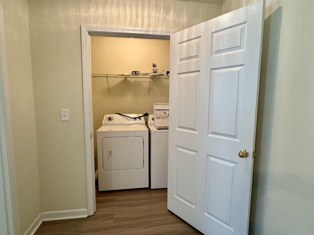 laundry room featuring separate washer and dryer and hardwood / wood-style floors