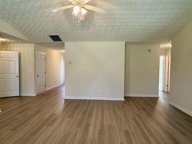 unfurnished room with dark wood-type flooring, a textured ceiling, and ceiling fan