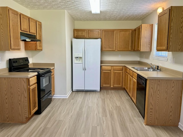 kitchen with sink, light hardwood / wood-style flooring, a textured ceiling, and black appliances