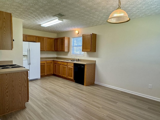 kitchen featuring sink, hanging light fixtures, black dishwasher, white refrigerator with ice dispenser, and light hardwood / wood-style floors