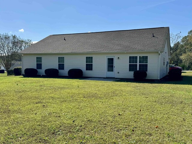 rear view of house with a lawn