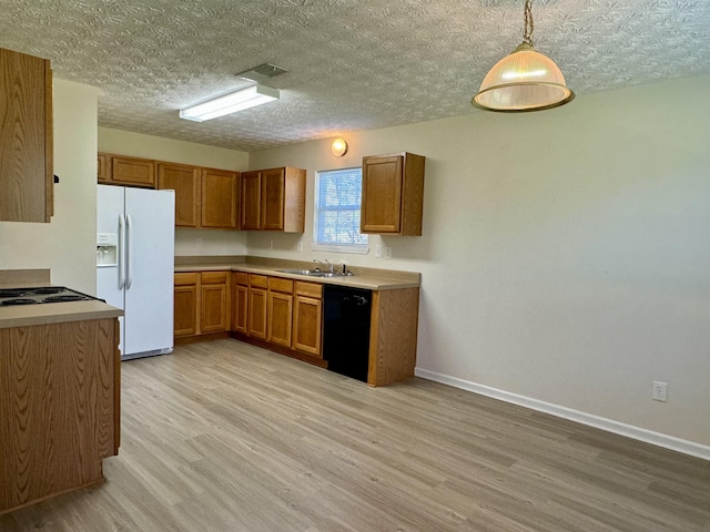 kitchen featuring sink, dishwasher, hanging light fixtures, white fridge with ice dispenser, and light wood-type flooring