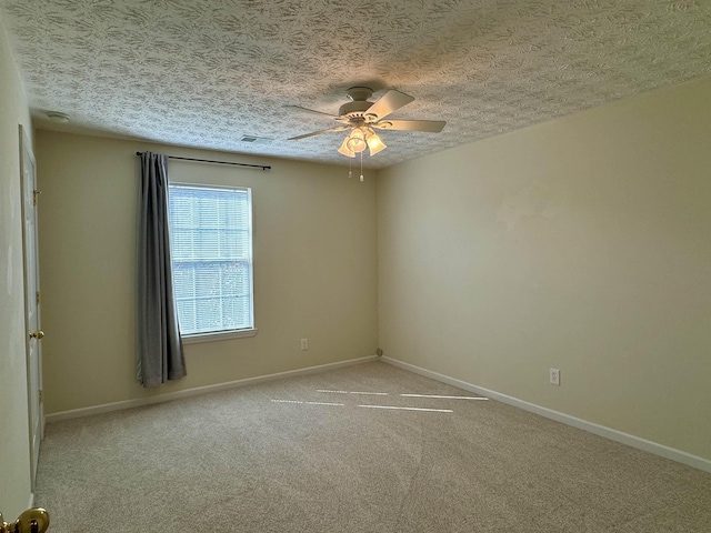 carpeted spare room with ceiling fan and a textured ceiling