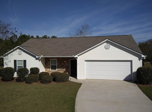 ranch-style home featuring a garage and a front lawn