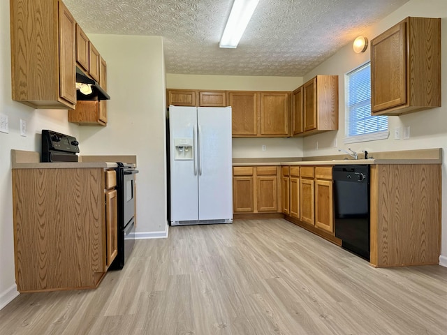 kitchen with sink, light hardwood / wood-style flooring, a textured ceiling, and black appliances