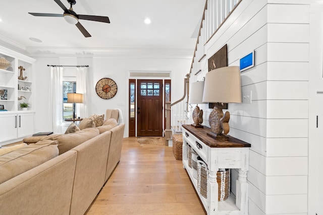 living room featuring recessed lighting, ceiling fan, crown molding, and light wood-style floors