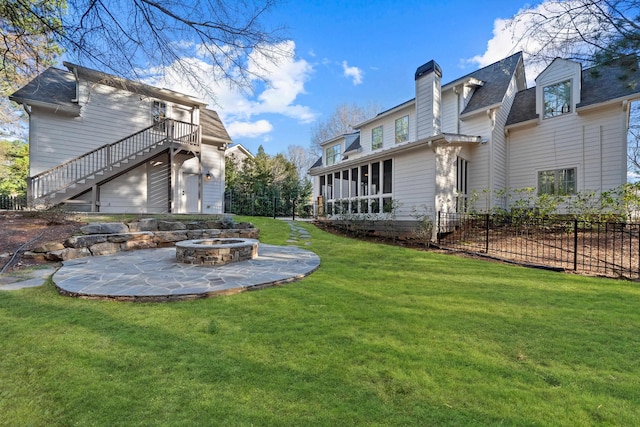 view of yard with a patio area, stairway, a fire pit, and fence