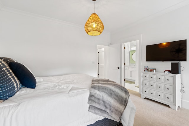 bedroom with carpet, ensuite bath, and crown molding