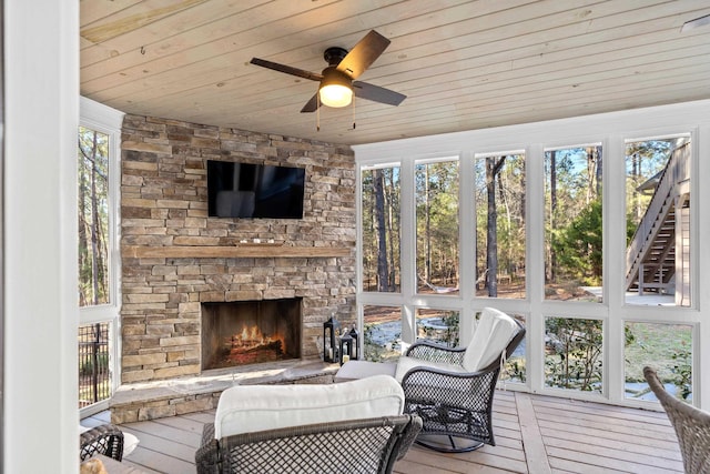 sunroom with wooden ceiling, a fireplace, and ceiling fan