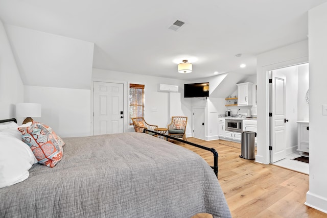 bedroom with light wood finished floors, visible vents, baseboards, vaulted ceiling, and recessed lighting