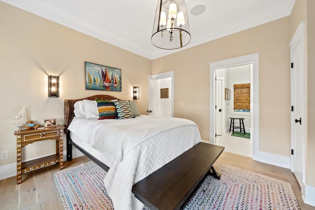 bedroom featuring an inviting chandelier, light wood-style floors, baseboards, and ornamental molding