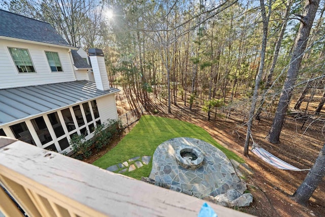 view of yard with an outdoor fire pit and fence