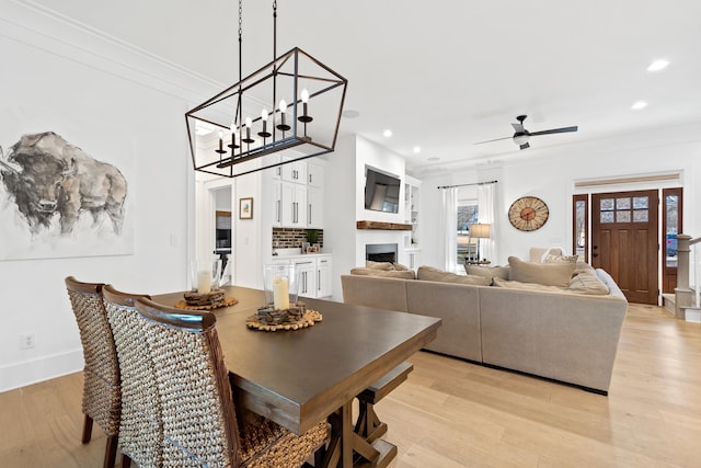 dining room featuring recessed lighting, light wood-style floors, ornamental molding, and a ceiling fan