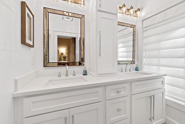 bathroom with double vanity and a sink