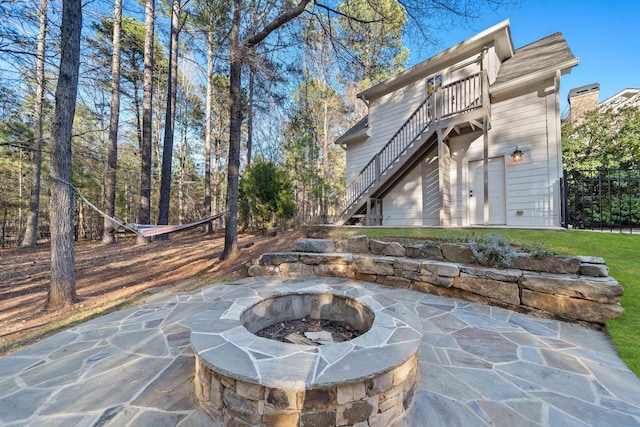 view of patio with stairway and an outdoor fire pit