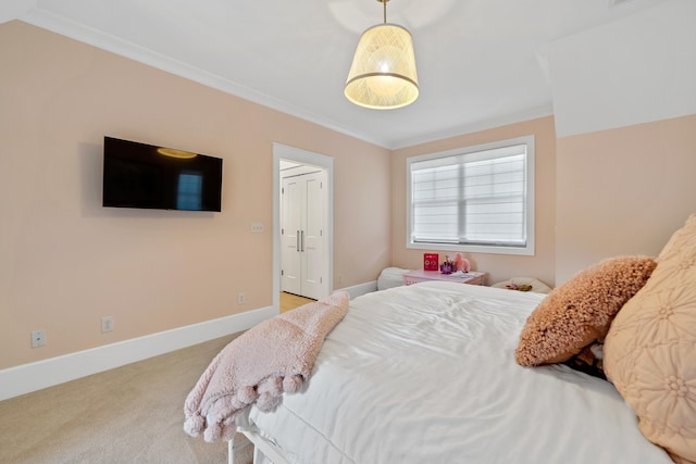 carpeted bedroom with baseboards and crown molding