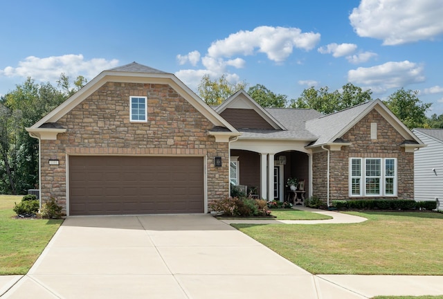 craftsman-style house featuring driveway, an attached garage, roof with shingles, and a front lawn