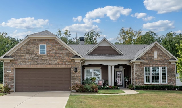 craftsman-style house featuring a shingled roof, concrete driveway, an attached garage, a front yard, and a chimney