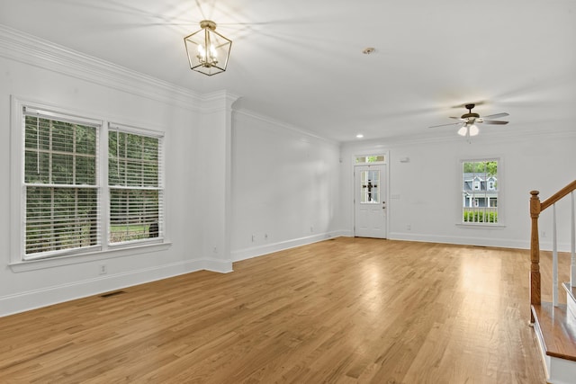 775 Markhams Dr, Madison, GA 30650 - unfurnished living room with light wood finished floors, baseboards, ornamental molding, stairs, and a ceiling fan